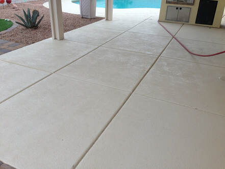 A concrete patio with a broom finish and decorative inlay
