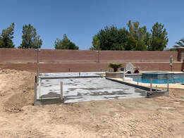 new concrete being installed around pool